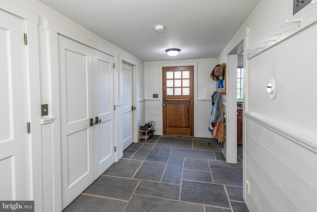 doorway with dark tile flooring