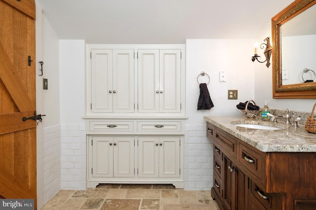 bathroom with tile flooring and large vanity