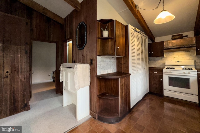 kitchen featuring white gas stove, dark tile floors, hanging light fixtures, and vaulted ceiling with beams