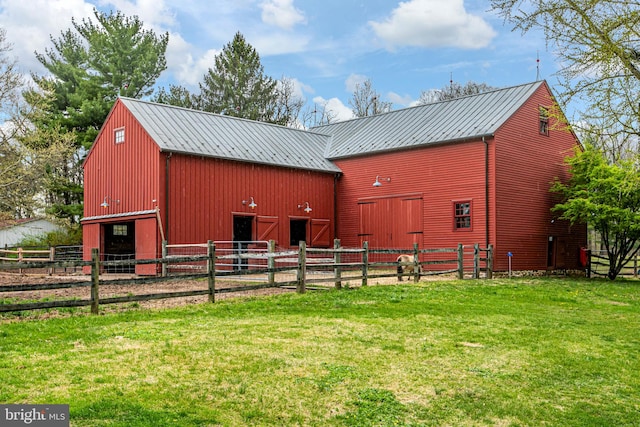 back of property featuring a yard and an outdoor structure