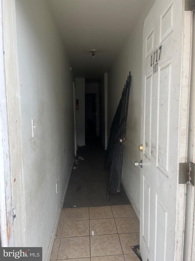 hallway featuring light tile flooring