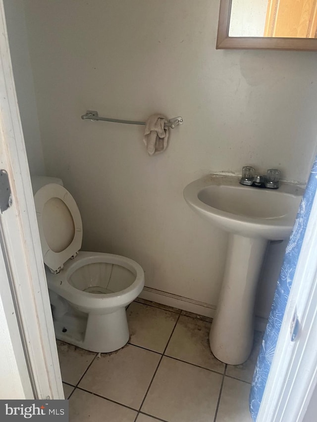 bathroom with toilet and tile flooring