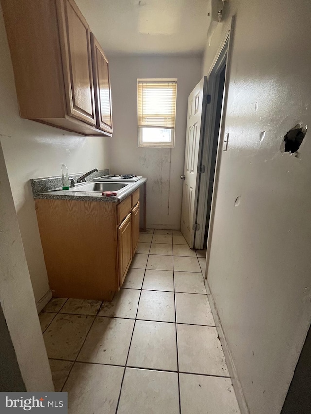 kitchen featuring sink and light tile floors