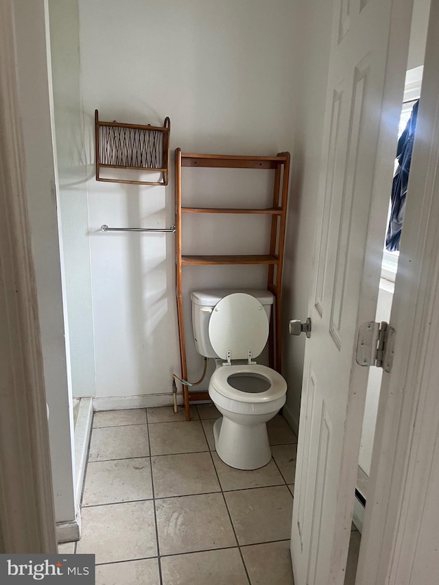 bathroom featuring toilet and tile floors