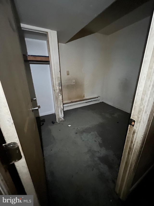 interior space featuring a baseboard radiator and concrete floors