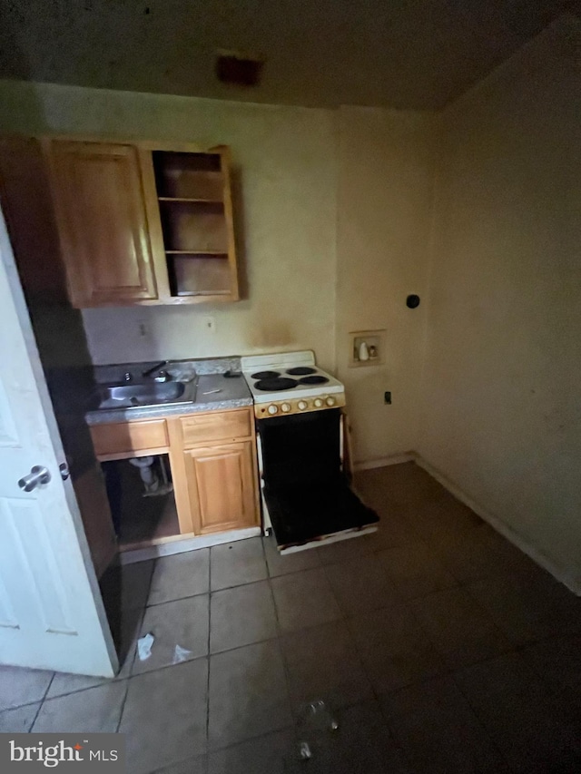 kitchen featuring sink, white electric range, and light tile floors