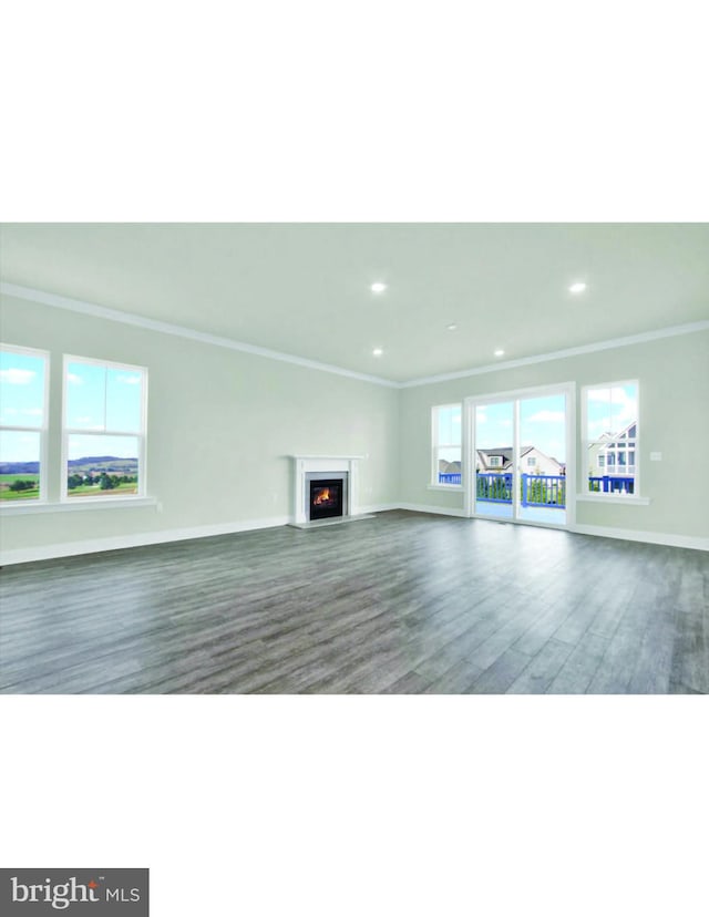 unfurnished living room with a healthy amount of sunlight, crown molding, and dark hardwood / wood-style floors