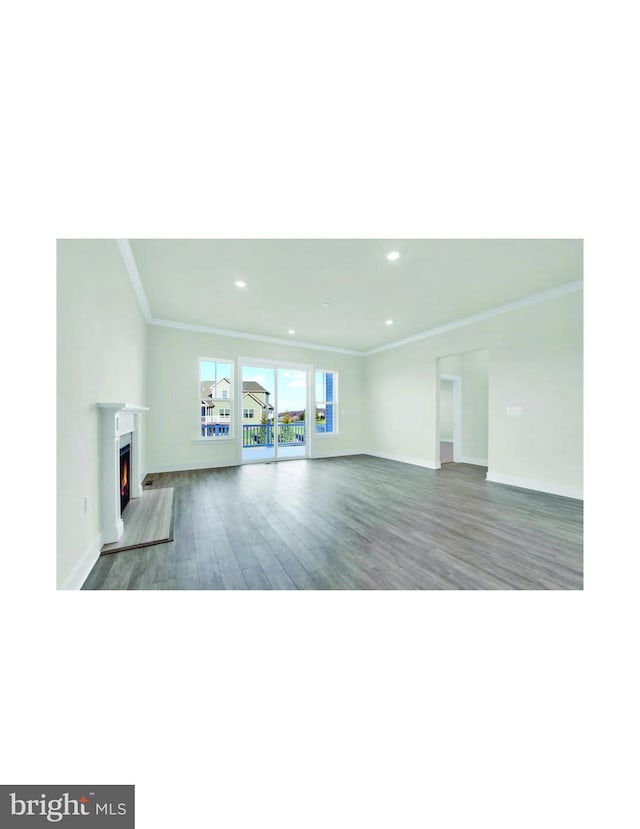 unfurnished living room featuring ornamental molding and dark wood-type flooring