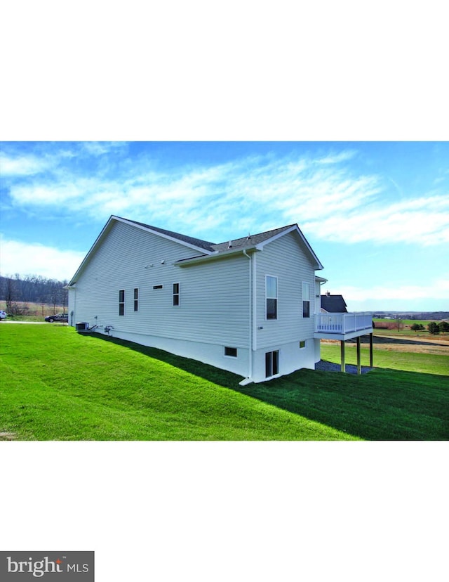 view of side of property with a lawn