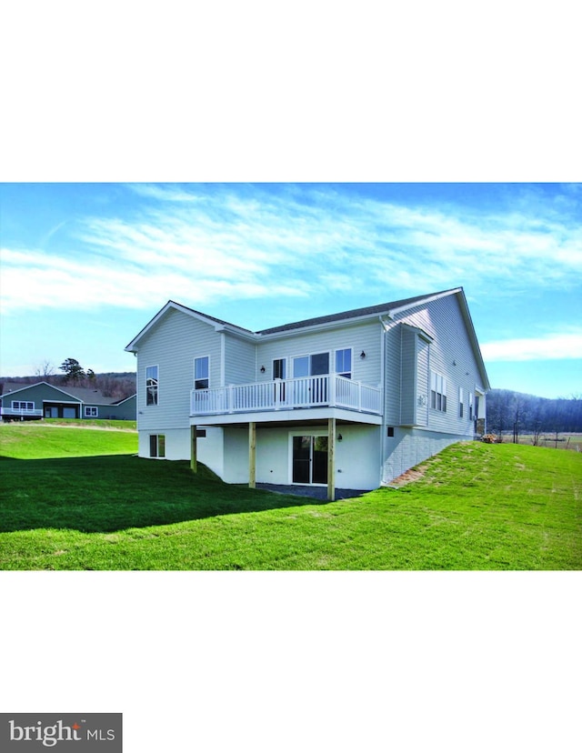 rear view of house featuring a lawn