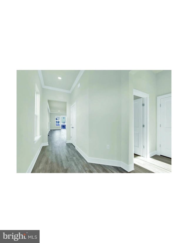 empty room featuring dark hardwood / wood-style flooring and crown molding