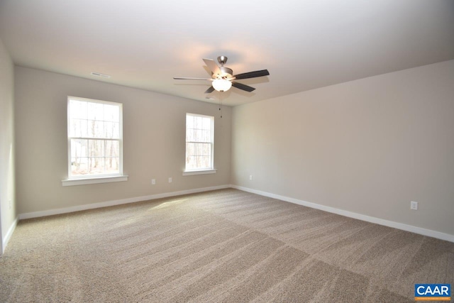 carpeted spare room featuring ceiling fan