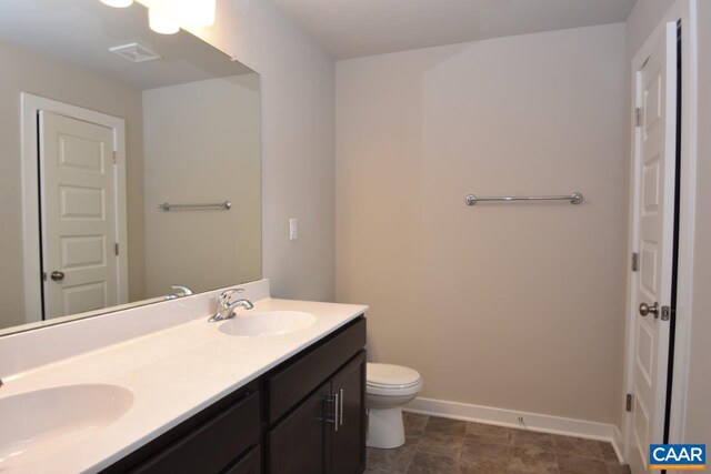 bathroom featuring tile patterned floors, vanity, and toilet