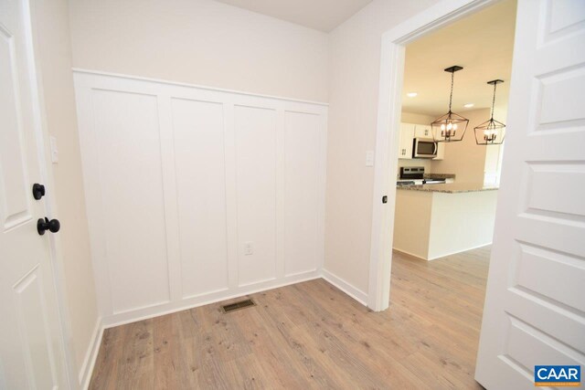 interior space with light hardwood / wood-style flooring and a chandelier