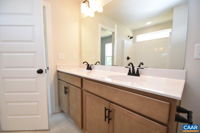 bathroom featuring tile patterned flooring and vanity