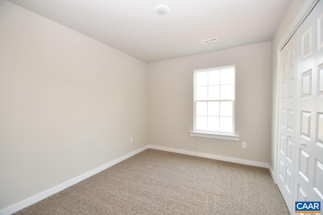 unfurnished bedroom with carpet floors and a closet