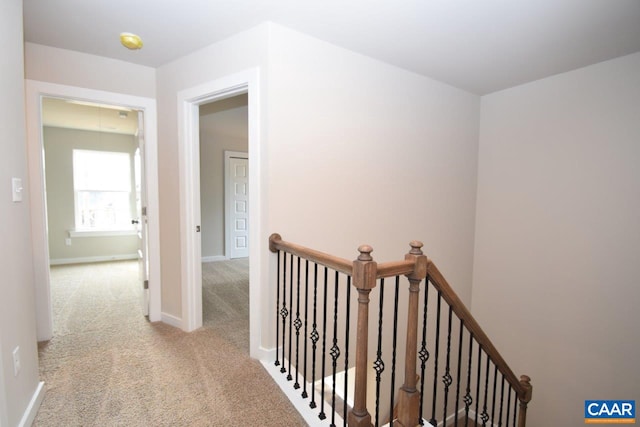 hallway with light colored carpet