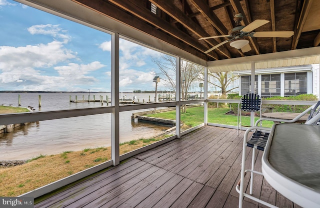 unfurnished sunroom featuring a water view and ceiling fan