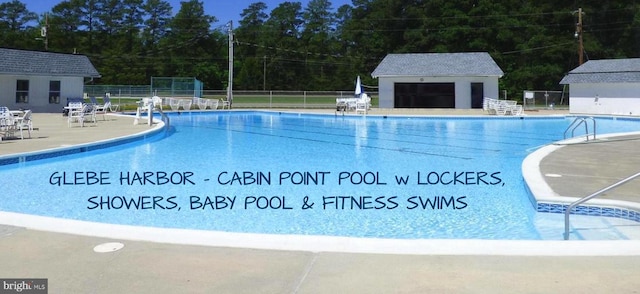 view of swimming pool featuring a patio area and an outdoor structure