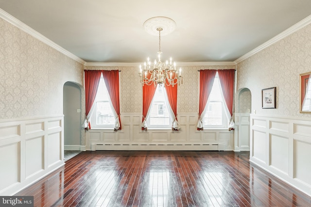 empty room featuring a baseboard radiator, crown molding, a chandelier, and dark hardwood / wood-style floors