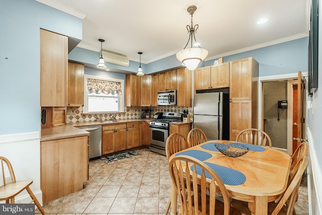 kitchen featuring pendant lighting, light tile flooring, crown molding, backsplash, and stainless steel appliances