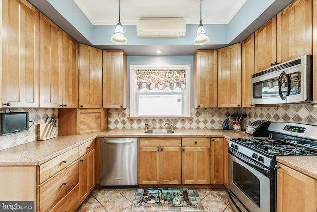 kitchen featuring decorative light fixtures, sink, appliances with stainless steel finishes, and an AC wall unit