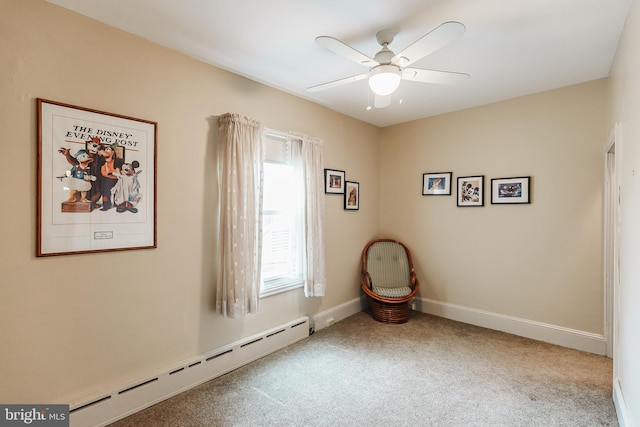 carpeted spare room with a baseboard heating unit and ceiling fan