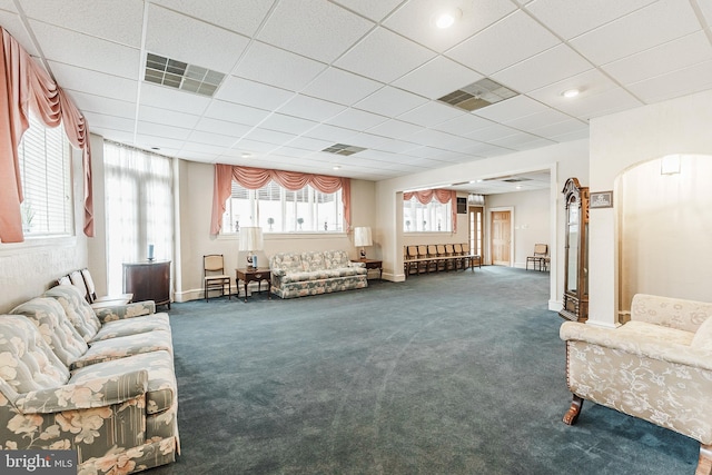 interior space featuring a drop ceiling and dark colored carpet