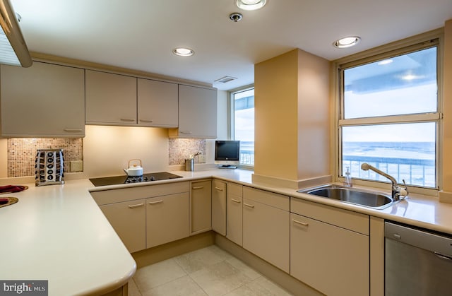 kitchen with stainless steel dishwasher, backsplash, light tile floors, and black electric stovetop