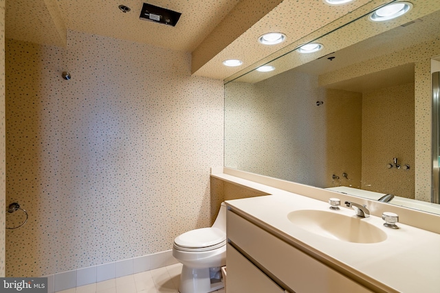 bathroom with oversized vanity, tile floors, and toilet