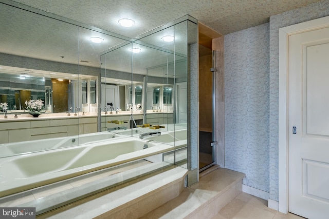 bathroom featuring tile flooring, separate shower and tub, and sink