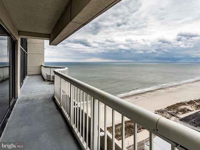 balcony with a beach view and a water view