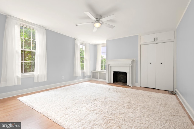 unfurnished living room featuring a healthy amount of sunlight, light hardwood / wood-style flooring, and ceiling fan