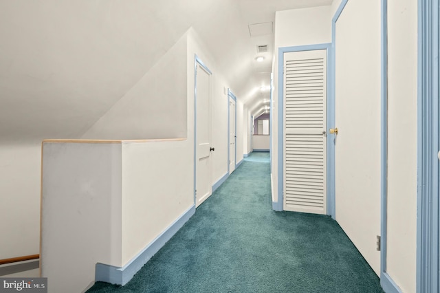 hallway with dark colored carpet