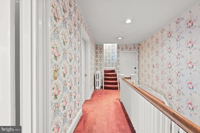 corridor with light colored carpet and radiator heating unit