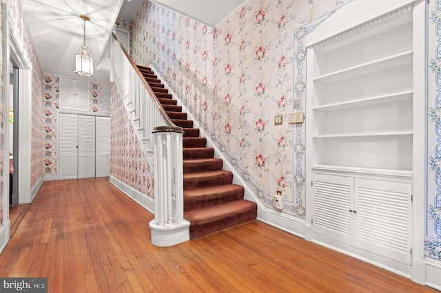 staircase with wood-type flooring