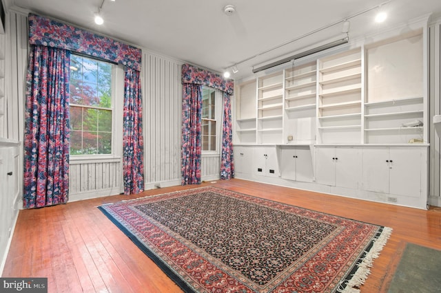 spare room with rail lighting and light wood-type flooring