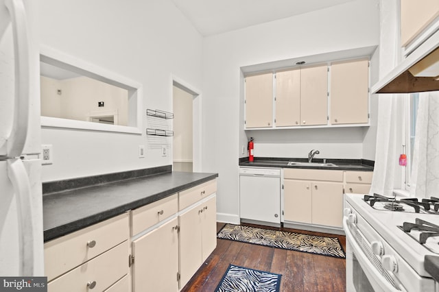 kitchen with sink, white appliances, white cabinetry, and dark wood-type flooring