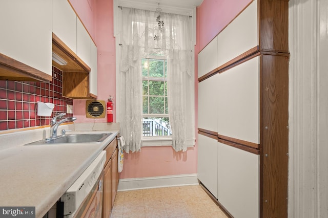 kitchen with light tile flooring, tasteful backsplash, white cabinetry, sink, and pendant lighting