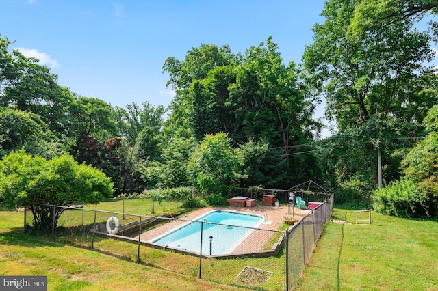 view of pool with a yard