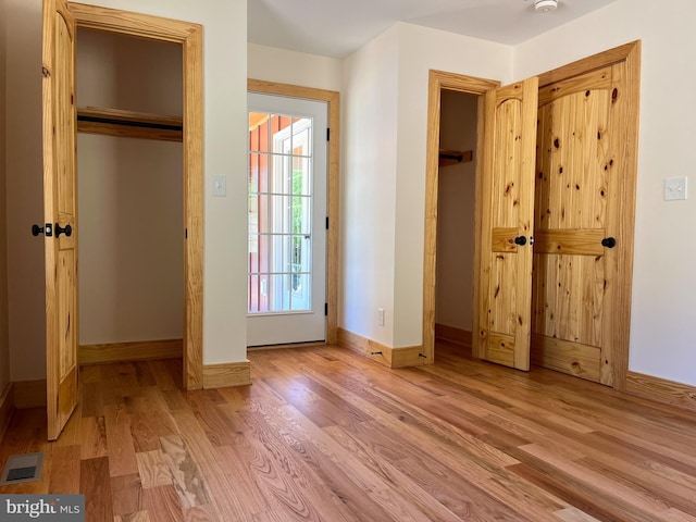 unfurnished bedroom with light wood-type flooring