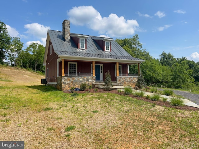 view of front of home with cooling unit, a front lawn, and a porch