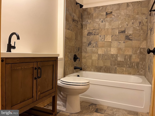 full bathroom with toilet, vanity, and tiled shower / bath