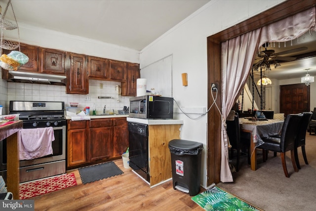 kitchen featuring sink, decorative backsplash, hanging light fixtures, stainless steel appliances, and crown molding