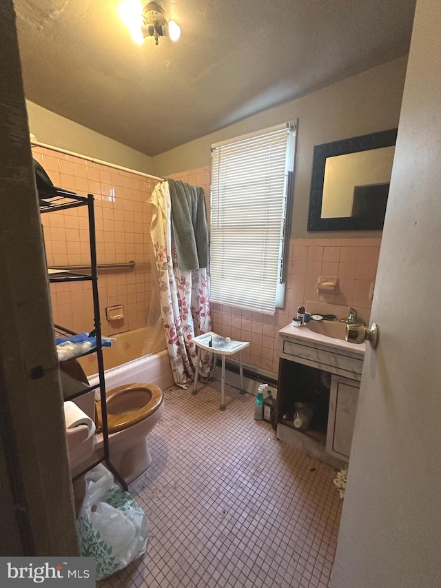 full bathroom with tile walls, oversized vanity, shower / bath combo, toilet, and tile floors