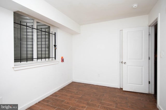 empty room with dark wood-type flooring