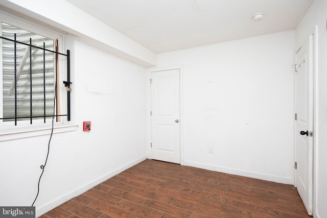 spare room with dark hardwood / wood-style flooring