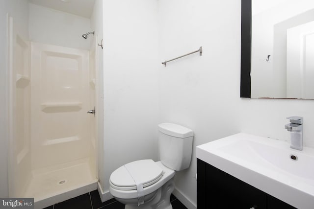 bathroom featuring a shower, vanity, toilet, and tile floors