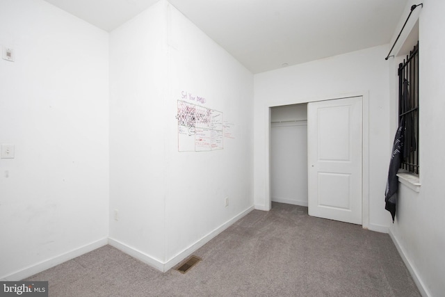 unfurnished bedroom with light colored carpet