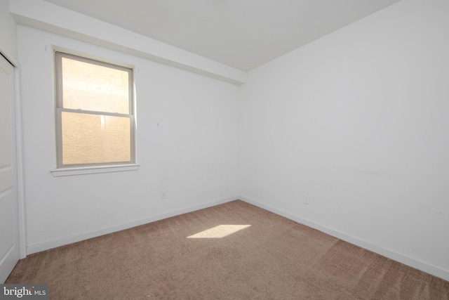 unfurnished room featuring light carpet